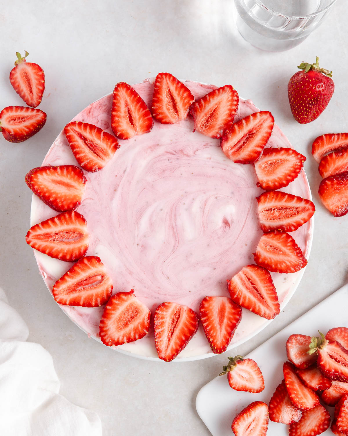The decoration process of a strawberry no-bake cake.