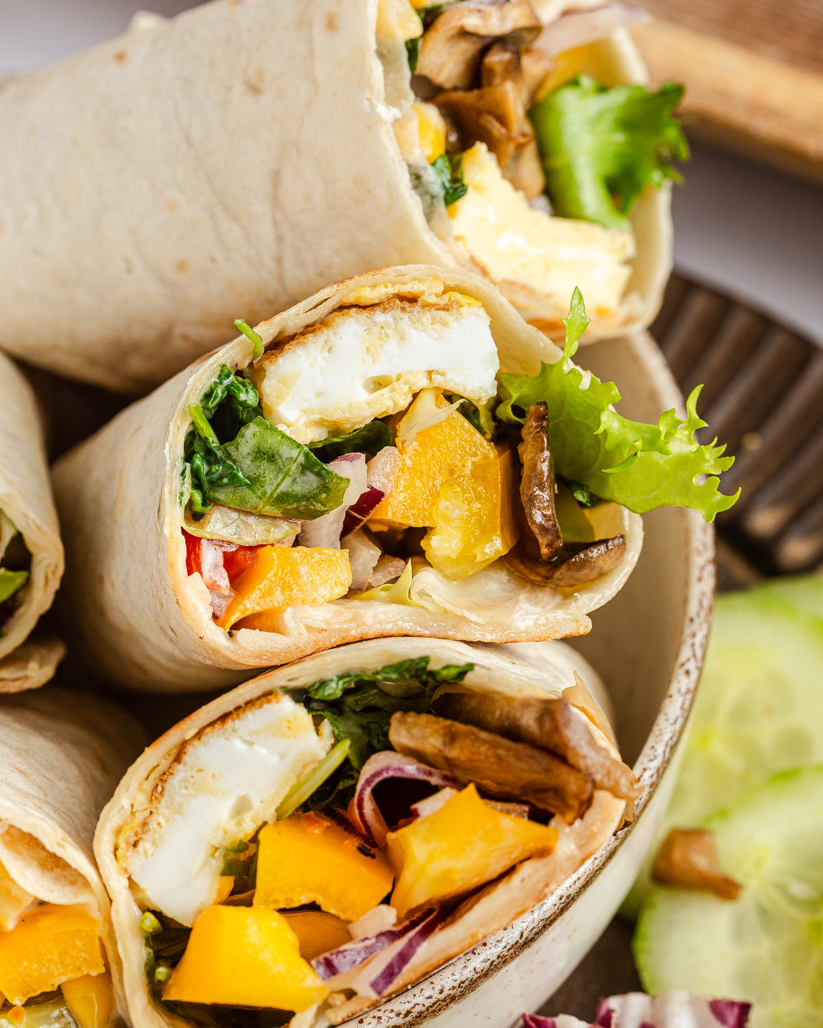 Tortilla wraps cut in half in a round bowl.