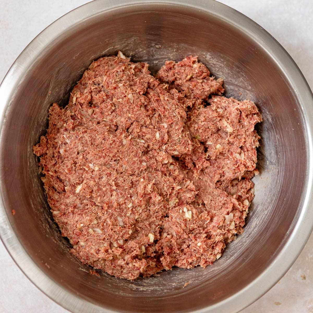 A bowl with beef kebab koobideh meat mixture.