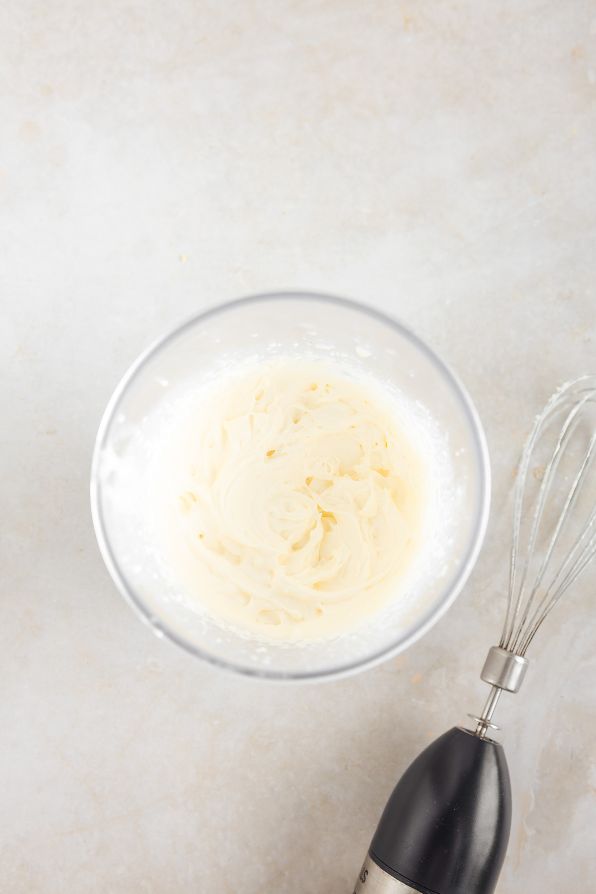 A transparent bowl with whipped cream.