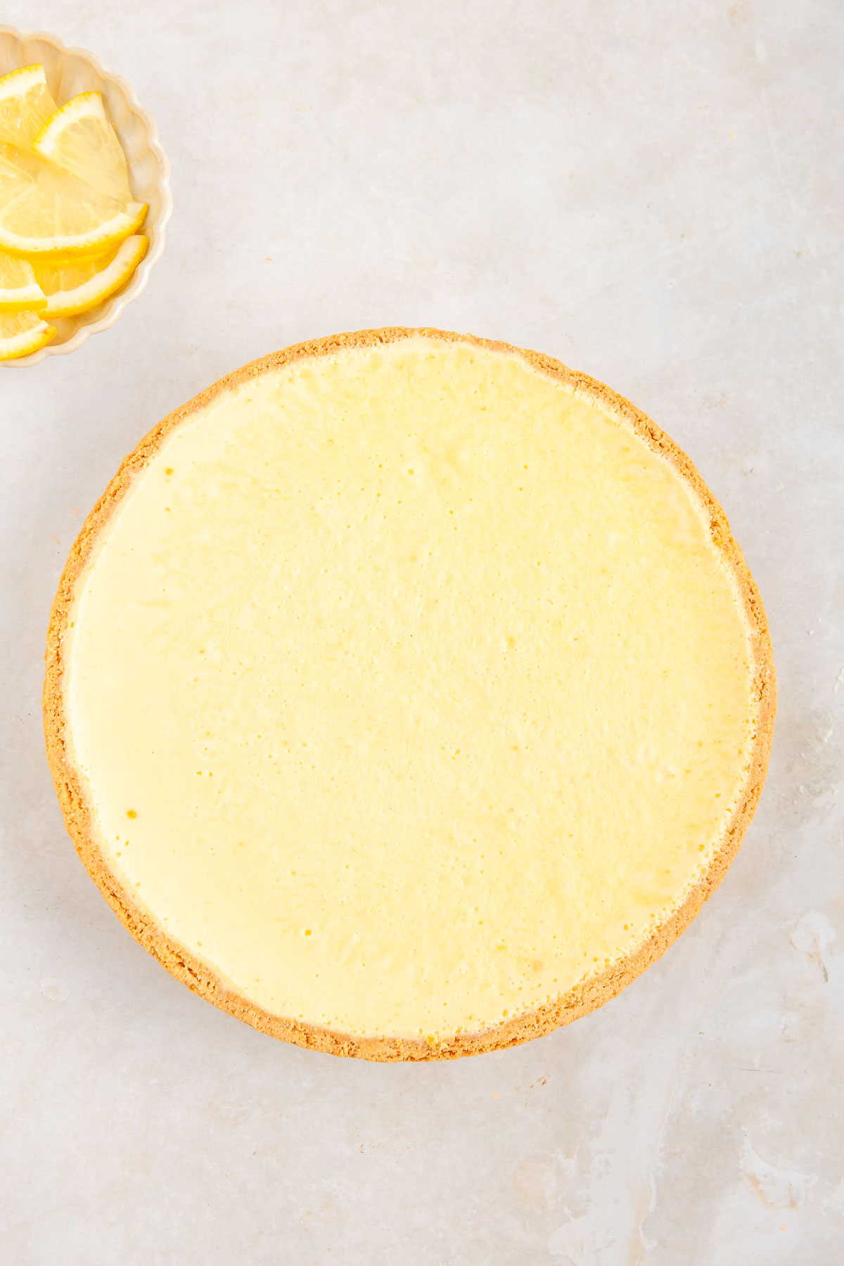 Undecorated lemon mousse tart, view from above.