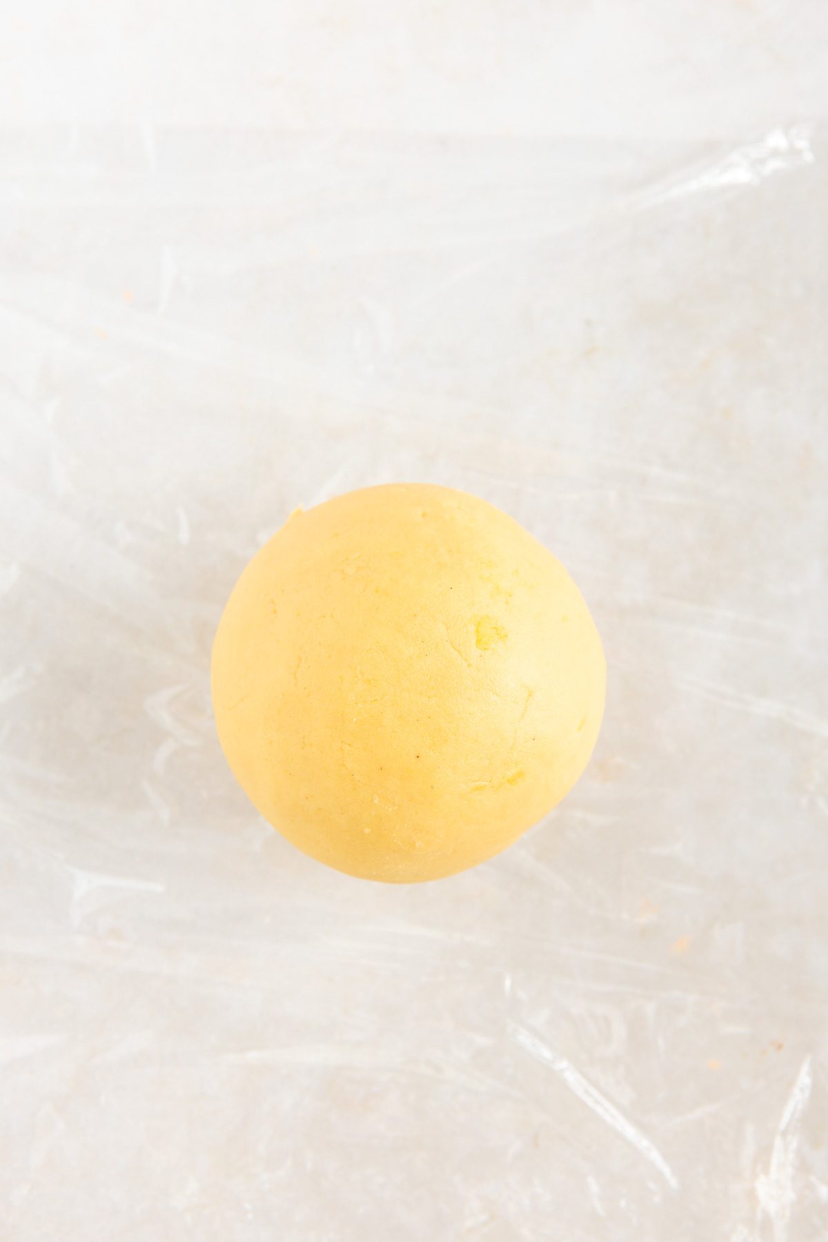 A round dough ball on a transparent film