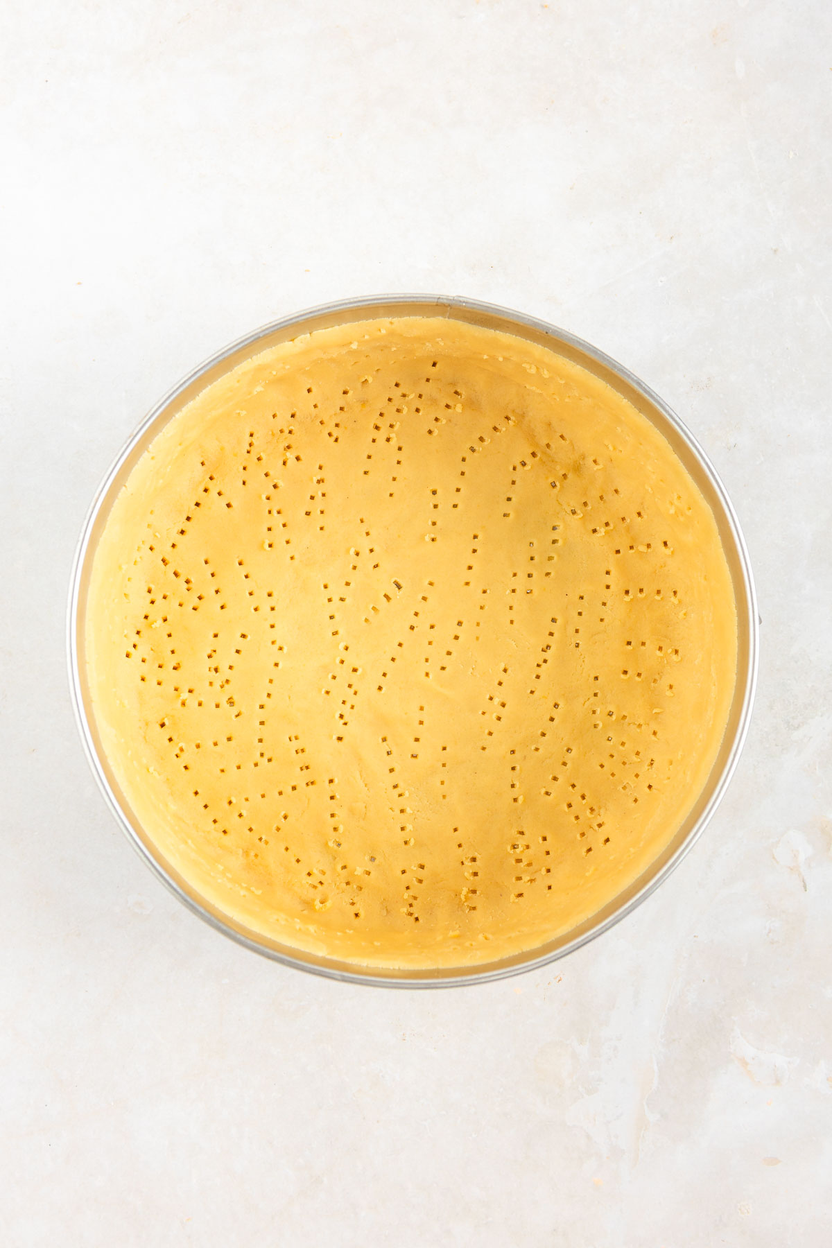 Unbaked base layer of a mousse lemon tart.