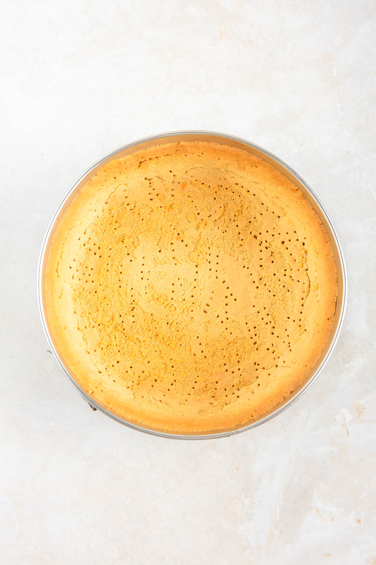 Baked base layer of a lemon mousse tart.