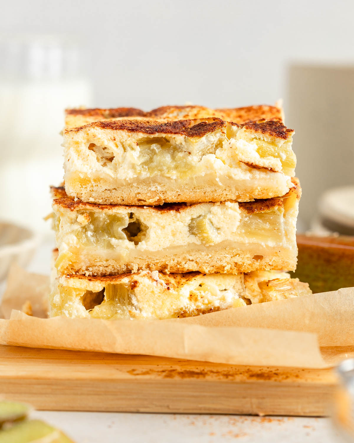 A stack of three slices of rhubarb sheet cake, side view.