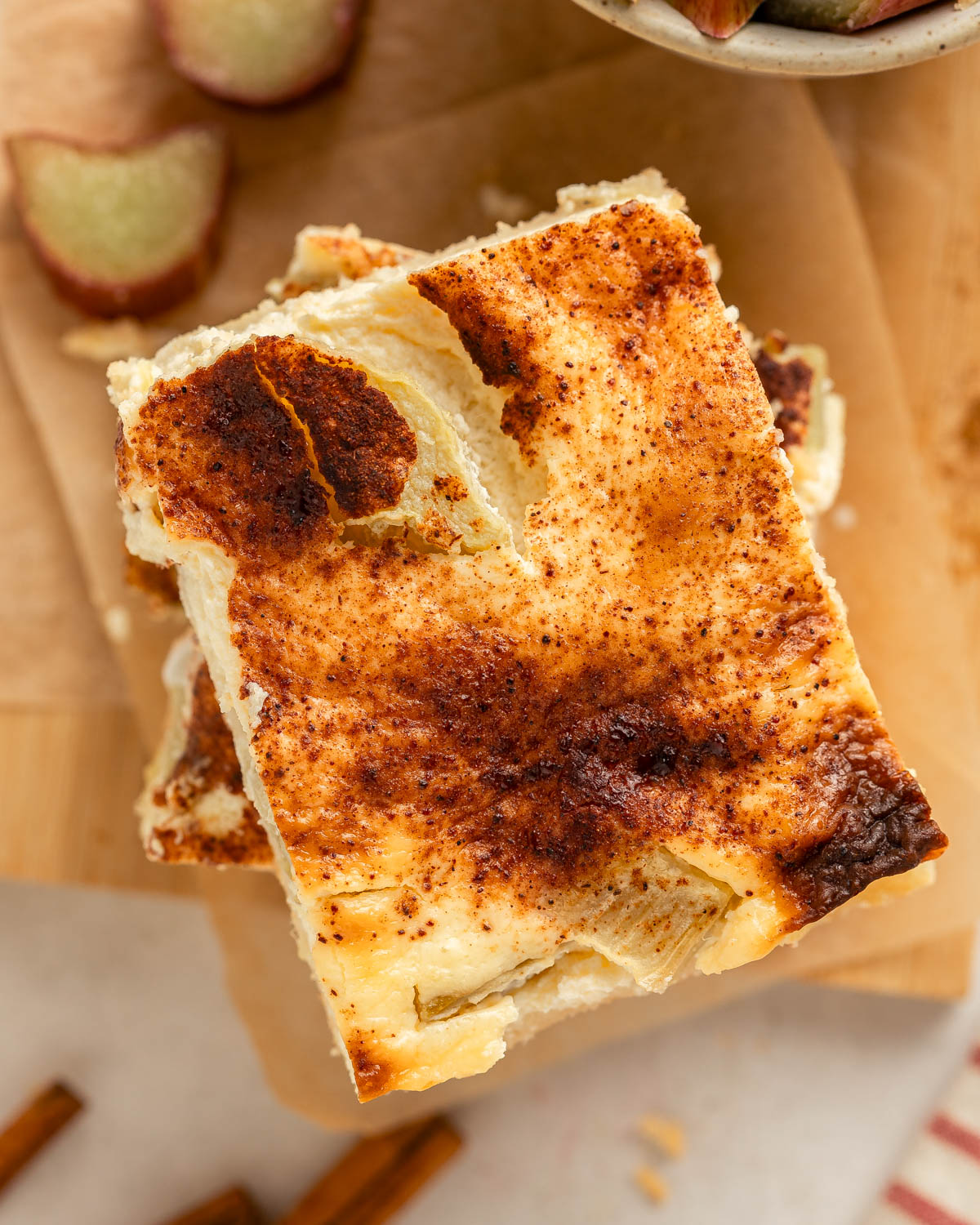 View from above onto a stack of rhubarb sheet cake slices.