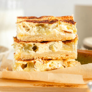 A stack of three slices of rhubarb sheet cake, side view.