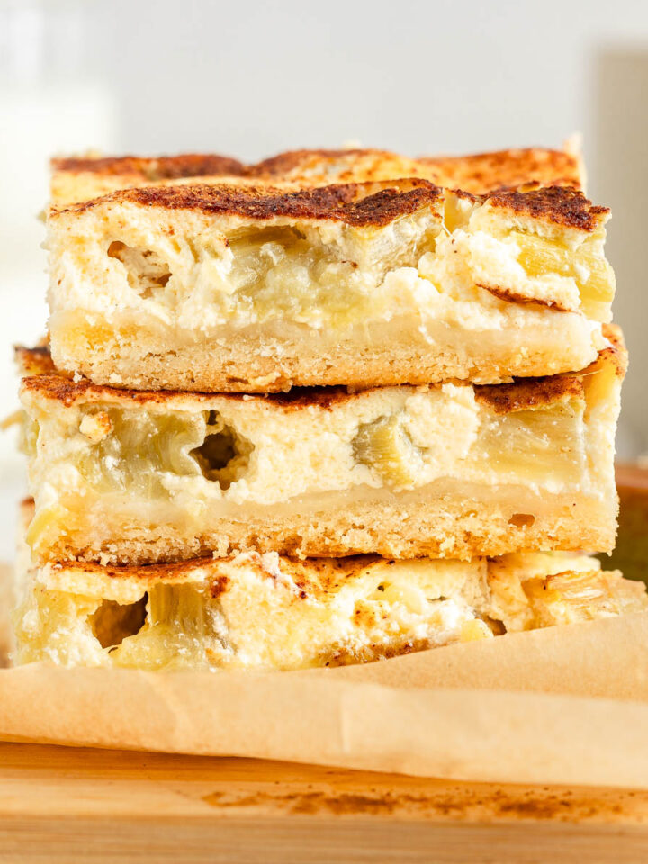A stack of three slices of rhubarb sheet cake, side view.