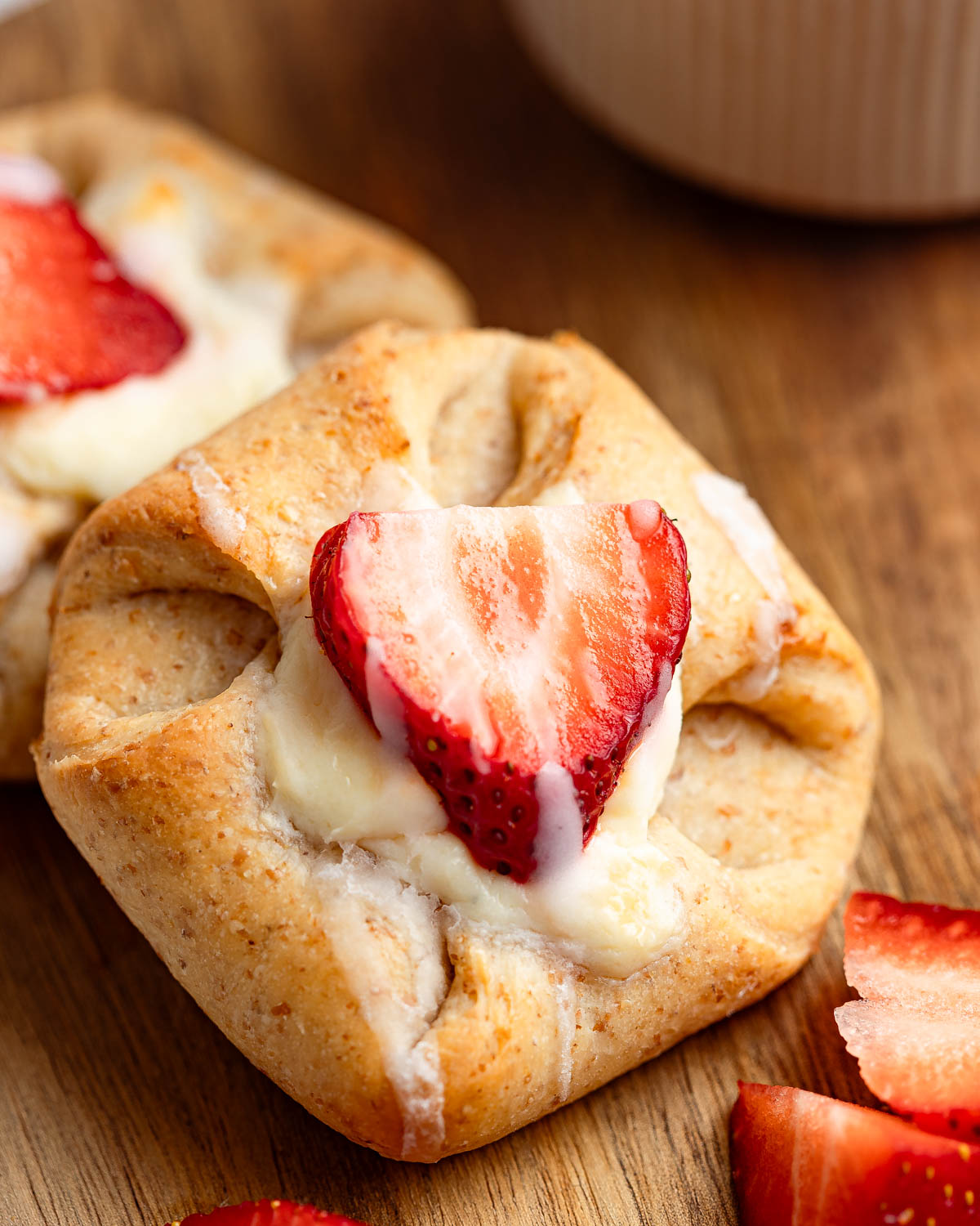 A top-down shot of a Danish sugar-free pastry with fresh strawberry slices on top and besides.