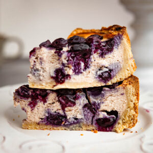 Stacked slices of blueberry sheet cake on a plate.