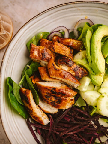 A closeup shot of hot honey chicken salad in a serving bowl.