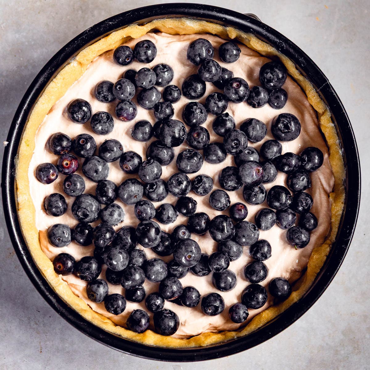 Blueberry pie with ricotta cheese being assembled.