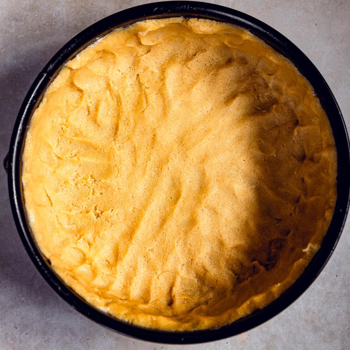 A cake springform with pressed dough.