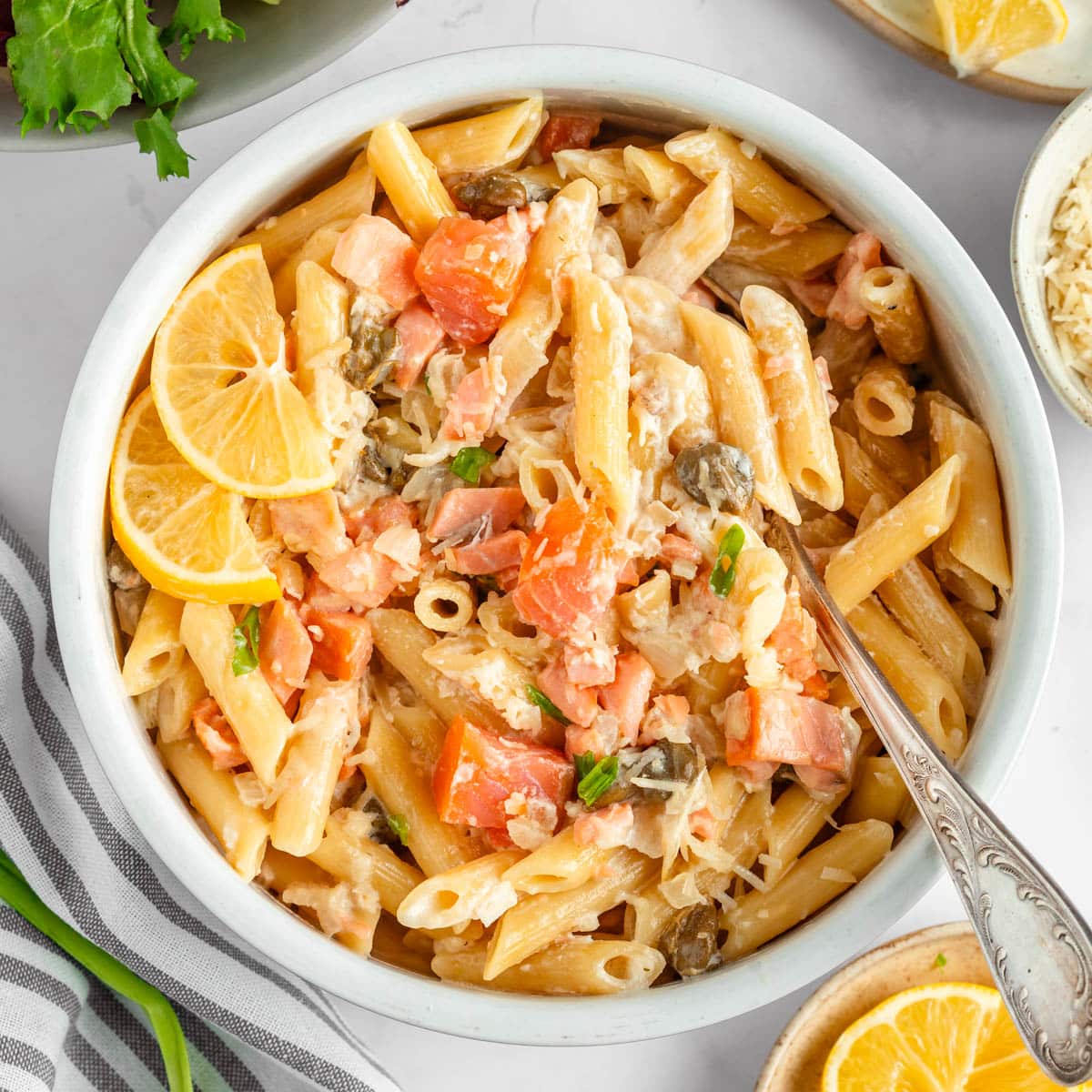 A top-down view on a round bowl with pasta salad with smoked salmon.