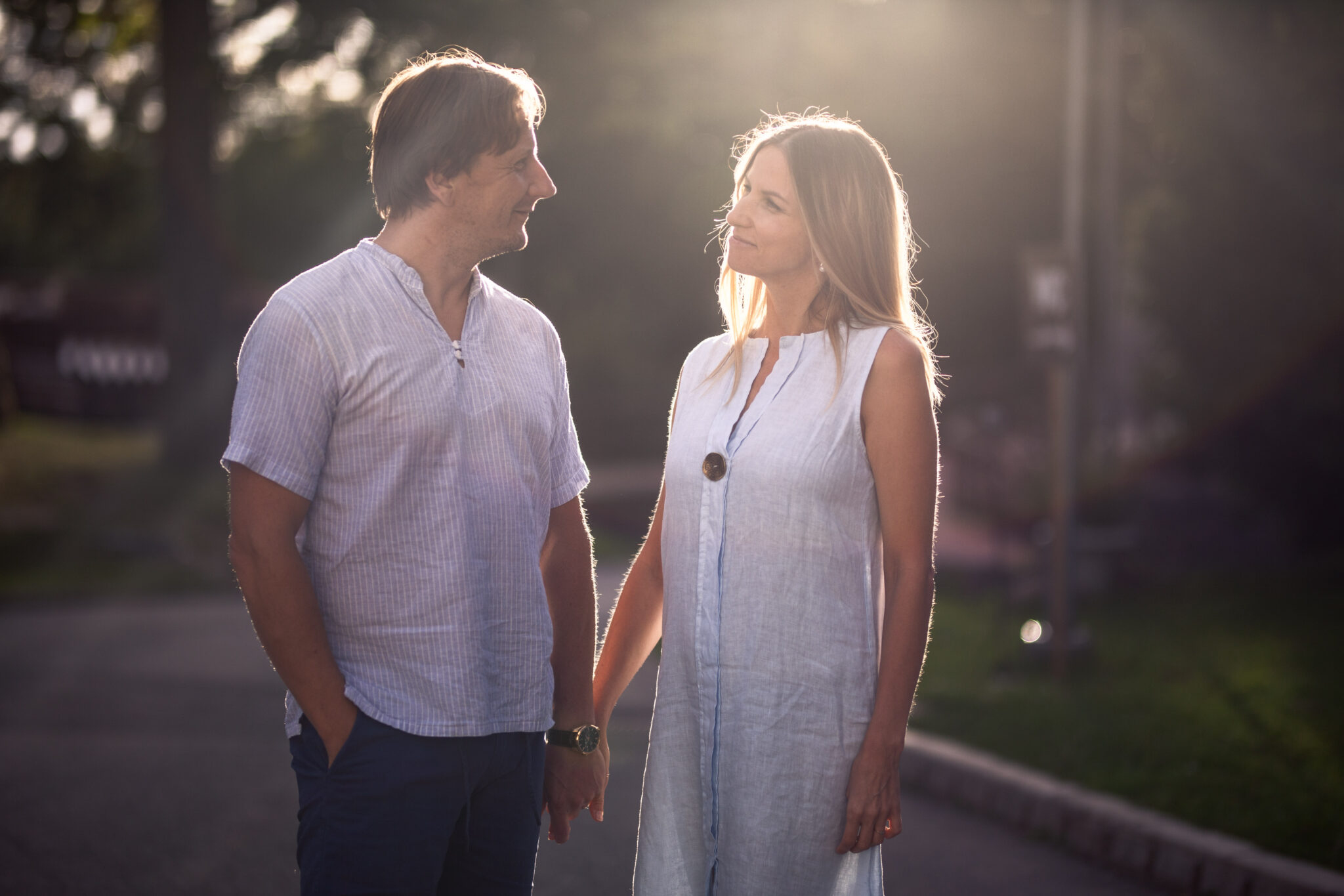 A man and a woman holding hands and looking at each other.